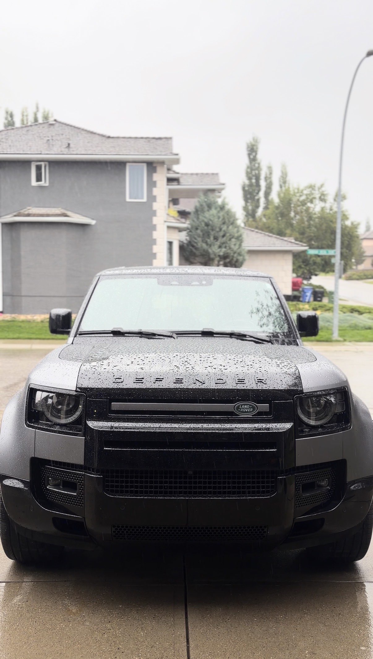 Land Rover Defender after a detail, beaded with rain